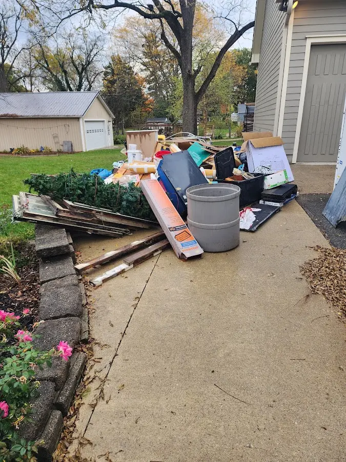 Dumpster being loaded with debris for Estate Cleanout Dumpster Rental in Bedminster